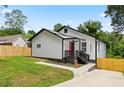 Charming home featuring a red door, crisp white siding, a welcoming front porch, and well-maintained landscaping at 951 Reed Ave, Atlanta, GA 30344