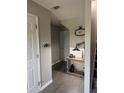 Well-lit entryway featuring a console table, modern lamp, decorative clock, and a staircase at 4210 Chatham Ridge Drive Dr, Buford, GA 30518