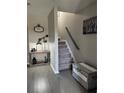 A staircase with gray carpeting and a decorative chest at the base with stylish decor at 4210 Chatham Ridge Drive Dr, Buford, GA 30518