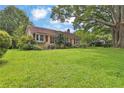 Charming one-story house with a well-manicured front lawn and mature trees at 4636 Chamblee Tucker Rd, Tucker, GA 30084