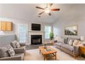 Inviting living room featuring vaulted ceilings, a fireplace, comfortable seating, and neutral tones at 5069 Jonesboro Rd, Union City, GA 30291