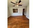 Light-filled living room featuring polished hardwood floors and a modern ceiling fan at 1098 Laurel Nw Ln, Conyers, GA 30012
