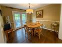 Dining area with a round wooden table, four chairs and a sliding door to a deck at 1280 Sanden Ferry Dr, Decatur, GA 30033