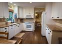 Bright kitchen featuring white cabinets, granite countertops, and stainless steel appliances at 1280 Sanden Ferry Dr, Decatur, GA 30033