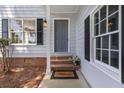 Charming home featuring a gray front door, brick steps, and classic black shutters at 1420 Fieldgreen Overlook, Stone Mountain, GA 30088