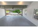 Clean garage interior with gray floor, white walls, and view of the driveway at 1420 Fieldgreen Overlook, Stone Mountain, GA 30088