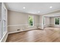 Bright, open living room featuring pristine walls and stunning laminate wood flooring at 1420 Fieldgreen Overlook, Stone Mountain, GA 30088