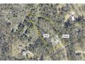Aerial view of a homesite on 2.29 acres in a wooded area with a marked plat overview at 5711 Hill View Dr, Oxford, GA 30054