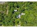 An overhead view of a home nestled among lush green trees in a serene setting at 5711 Hill View Dr, Oxford, GA 30054