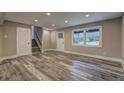 Finished basement with new flooring, recessed lighting and an entry door at 1675 Bouldercliff Se Ct, Atlanta, GA 30316