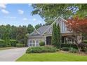 Charming home featuring a well-manicured lawn, a two-car garage, and beautiful landscaping at 308 Shade Tree Cir, Woodstock, GA 30188