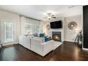 Cozy living room featuring a fireplace, ceiling fan, and comfortable seating area at 7086 Gladstone Cir, Lithonia, GA 30038