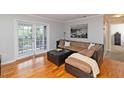 Well-lit living room featuring hardwood floors, a cozy sectional, and patio access at 1150 Collier Nw Rd # B5, Atlanta, GA 30318