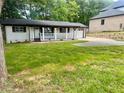 Traditional home with a well-maintained front lawn, front porch, and a single car garage at 256 New Hope Rd, Lawrenceville, GA 30046