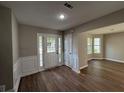 Inviting foyer with new hard surface flooring and natural light streaming through the sidelight windows at 4189 Post Oak Grv, Atlanta, GA 30349