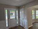 Inviting foyer with new hard surface flooring and natural light streaming through the sidelight windows at 4189 Post Oak Grv, Atlanta, GA 30349