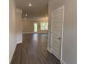 Inviting hallway showcasing durable wood-look flooring and neutral paint, leading to the spacious living area at 3383 Milan Ct, Douglasville, GA 30135
