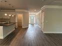 Open living space featuring wood-look floors, recessed lighting, and an eat-in kitchen space at 3383 Milan Ct, Douglasville, GA 30135