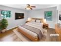 Comfortable main bedroom featuring two windows for natural light and stylish, staged decor at 3867 Cherie Glen Rd, Snellville, GA 30039
