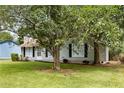 Cozy single-story home with a well-manicured front lawn, shaded by mature trees, and a welcoming entrance at 183 Peachtree Ct, Riverdale, GA 30274