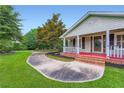 Close-up of home's front porch with brick steps and a curving driveway at 5190 Due West Nw Rd, Powder Springs, GA 30127