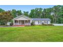 Well maintained single-story home with a landscaped lawn and inviting front porch at 5190 Due West Nw Rd, Powder Springs, GA 30127