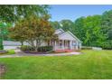 Charming single story home with a lush green lawn and meticulously maintained landscaping at 5190 Due West Nw Rd, Powder Springs, GA 30127