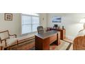 Bright home office with ample desk space, natural light, and traditional decor at 995 Lewis Ridge Cir, Lawrenceville, GA 30045