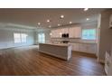 Open kitchen featuring a large island, granite countertops, stainless appliances, and ample natural light at 5311 Tuscany Dr, Douglasville, GA 30135