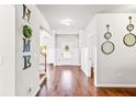 Open foyer with hardwood floors, decorative mirrors, and a view of the main entry door at 125 Atkins Ln, Fayetteville, GA 30215