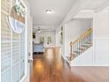 Inviting entryway featuring hardwood floors and staircase, leading into a bright living space at 125 Atkins Ln, Fayetteville, GA 30215