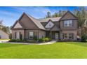 Charming two-story home with beautiful exterior, manicured lawn, and inviting curb appeal at 125 Atkins Ln, Fayetteville, GA 30215