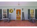 Cozy front porch with rocking chairs, charming decor, and a welcoming entrance at 3743 Johnston Rd, Winston, GA 30187