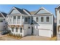 Stunning two-story home featuring white brick, gray siding, a balcony, and a two-car garage at 89 Batten Board Way, Woodstock, GA 30189