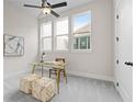 Bright office space featuring a glass desk, neutral carpet, three windows, and modern decor at 89 Batten Board Way, Woodstock, GA 30189