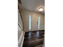 Inviting foyer with wood-look flooring and a bright white front door with side windows at 11800 Carriage Park Ln, Johns Creek, GA 30097