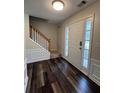 Inviting foyer with wood-look flooring and a bright white front door with side windows at 11800 Carriage Park Ln, Johns Creek, GA 30097