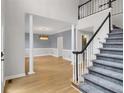 Inviting foyer with staircase, hardwood floors, and elegant chandelier at 140 Heritage Ct, Fayetteville, GA 30214