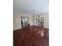 Elegant living room with gleaming hardwood floors and classic chandelier at 2209 Willow Crest Cir, Lawrenceville, GA 30044