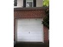 Spacious single-car garage with a classic white door and brick facade at 4018 Carisbrook Dr, Union City, GA 30291