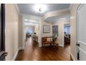 Elegant hallway with dark hardwood floors, decorative lighting, and access to living areas with city views at 2660 Peachtree Nw Rd # 13F, Atlanta, GA 30305