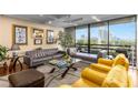 Bright living room featuring modern furniture, artwork, and floor-to-ceiling windows with scenic views at 2660 Peachtree Nw Rd # 13F, Atlanta, GA 30305