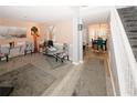 Inviting living room with neutral walls, gray carpet, and adjacent dining area at 1964 Cutters Mill Way, Lithonia, GA 30058