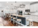Modern kitchen with white cabinets, granite countertops, an island, and stainless steel appliances at 505 Hampton Crossing, Woodstock, GA 30188