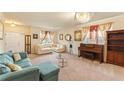 Comfortable living room featuring stylish decor, a piano, and ample seating at 12148 Flannery Ln, Hampton, GA 30228