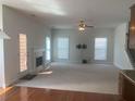 Large open living room with a fireplace, ceiling fan, TV mount and lots of natural light at 2118 Water Mill Ct, Buford, GA 30519