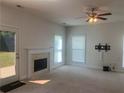 Bright open living room with a fireplace, ceiling fan, and tv mount at 2118 Water Mill Ct, Buford, GA 30519