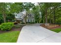 A long driveway leads to this beautifully landscaped home with mature trees at 700 Broadlands Ln, Powder Springs, GA 30127