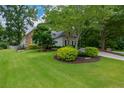 Manicured lawn leads to this home featuring stone accents and beautifully landscaped beds at 700 Broadlands Ln, Powder Springs, GA 30127