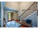 Inviting foyer featuring hardwood floors, staircase with iron railing, and natural light at 700 Broadlands Ln, Powder Springs, GA 30127